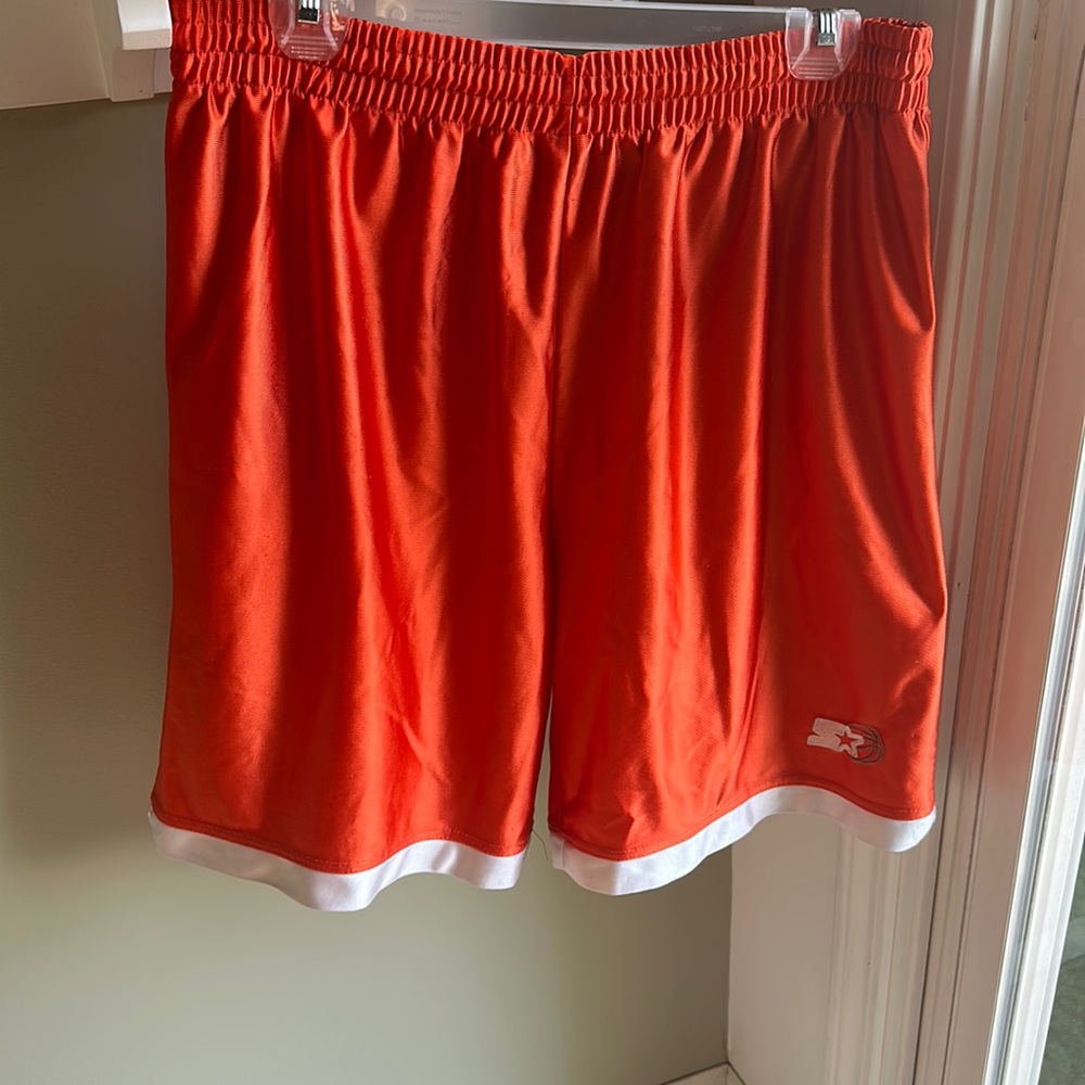 These are orange STARTER shorts in the size men’s medium